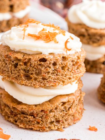 A double-layer mini carrot cake with cream cheese frosting on top.