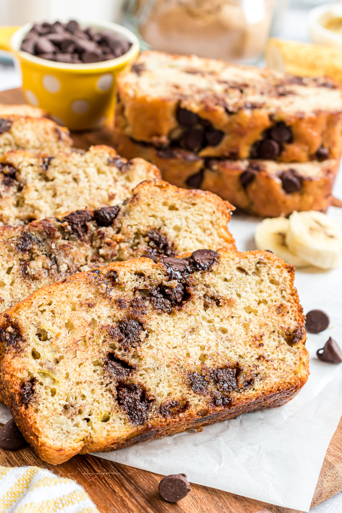 Two large slices of baked banana bread with pancake mix showing the moist texture of the bread and the distribution of chocolate chips.