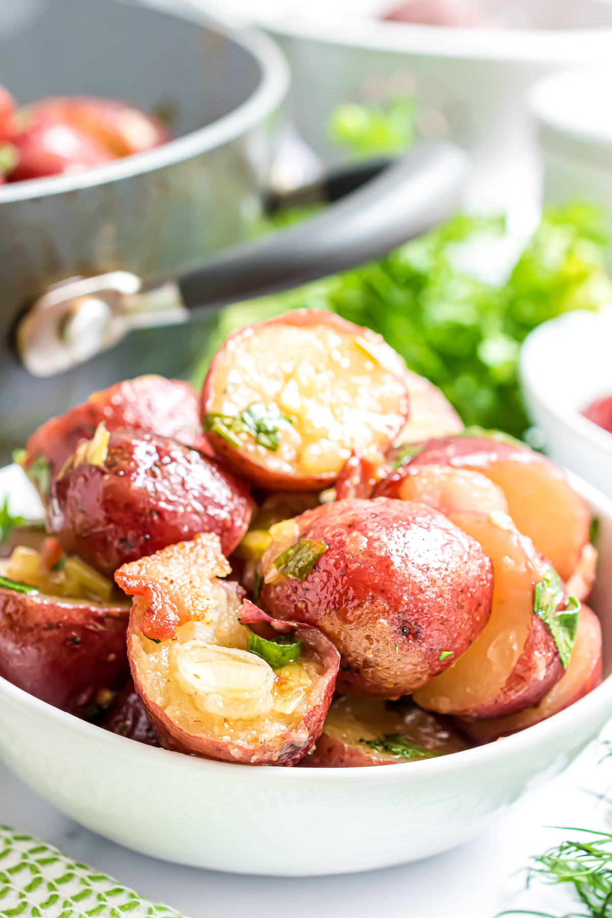 A heaping serving of the warm potato salad in a bowl.