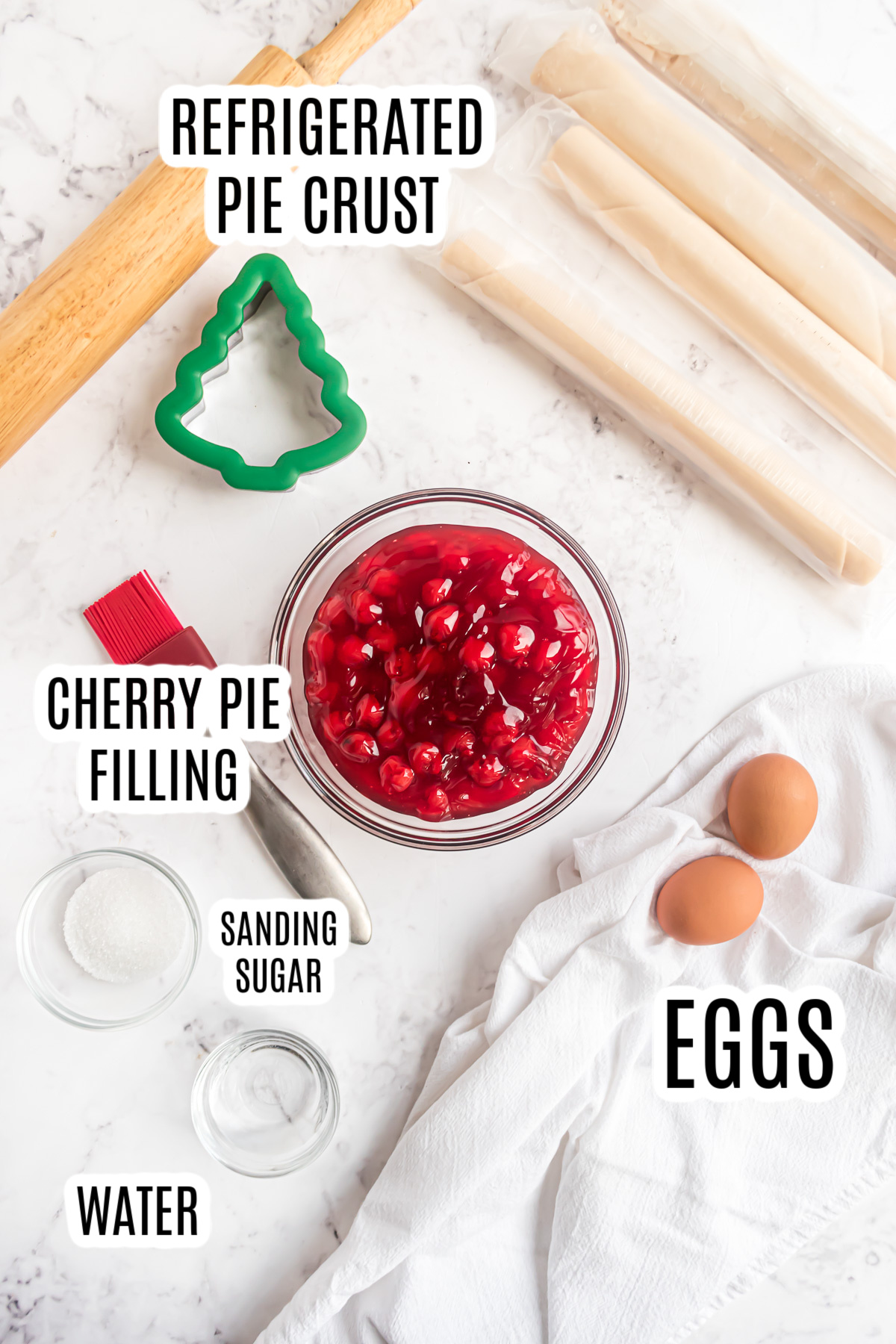All of the ingredients need to make the cherry hand pies including refrigerated pie crust, canned cherry pie filling, eggs, sanding sugar and water.