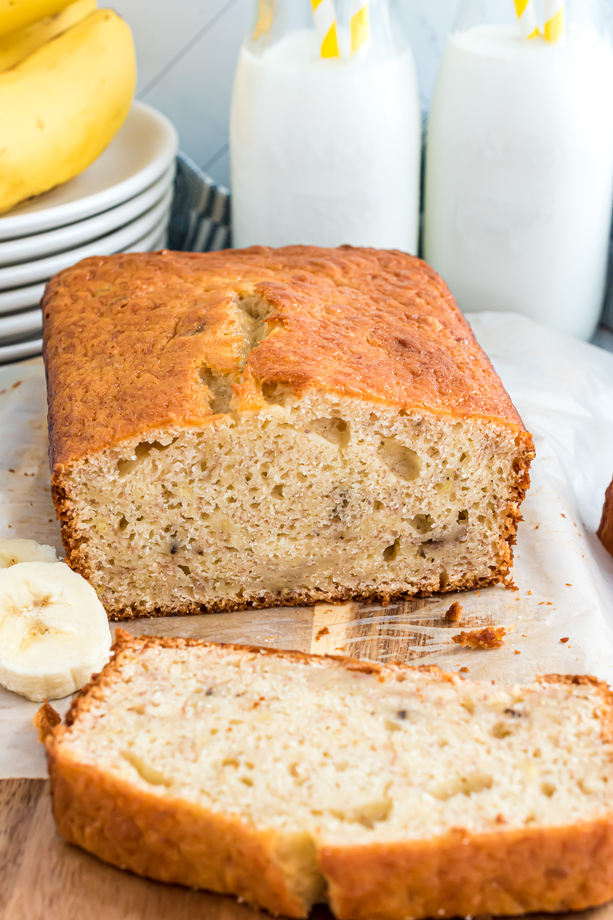 A loaf of banana bread with the end slice cut off to reveal the inside texture of the loaf.