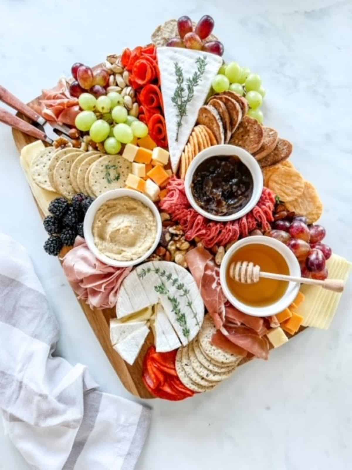 A gluten-free meat and cheese board featuring speciality ingredients.