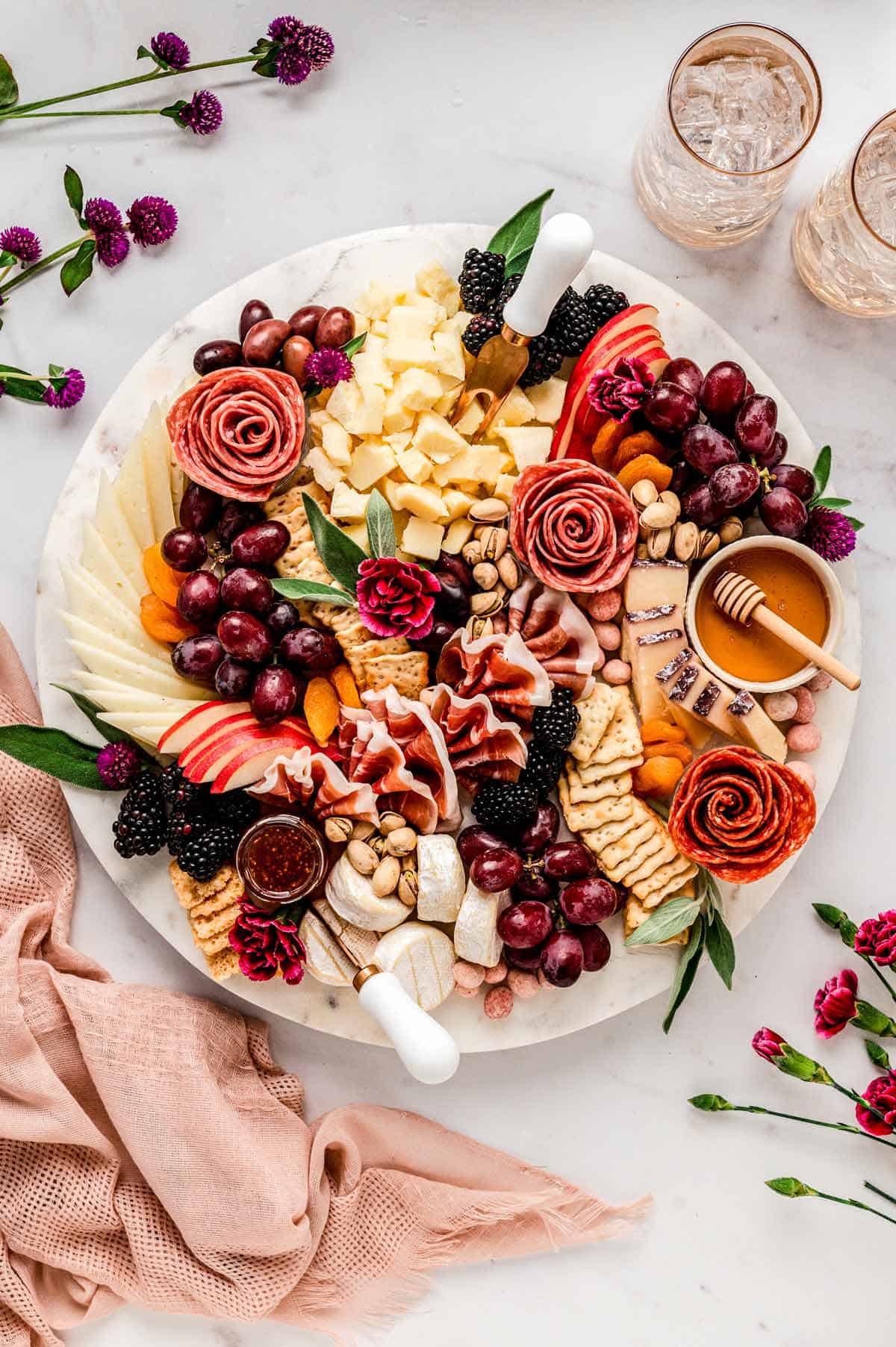 A charcuterie board featuring fruits, cheese and meat.