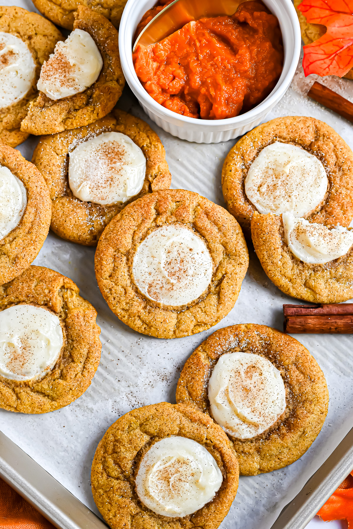 Pumpkin Cheesecake Cookies on a parchment lined cookie sheet.