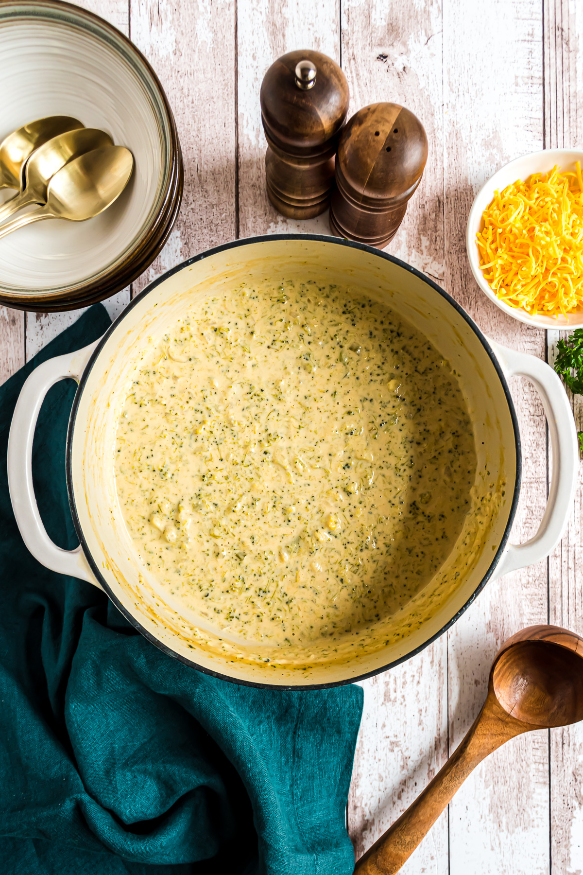 A large Dutch oven filled with broccoli cheese soup.