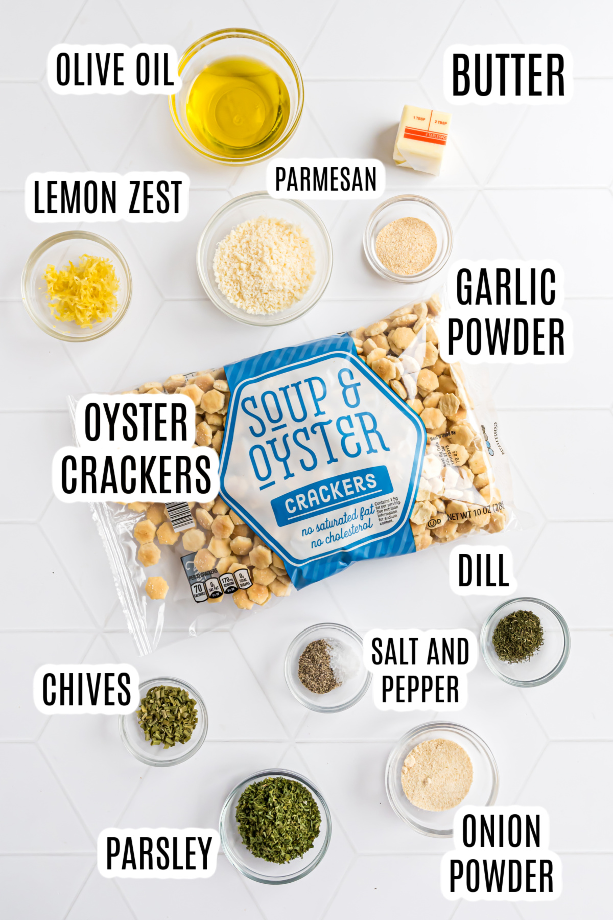 The ingredients required to make this Soup Cracker Recipe include: oyster crackers, butter, olive oil, dried dill, salt and pepper, dried chives, dried parsley, onion powder, garlic powder, and parmesan cheese.
