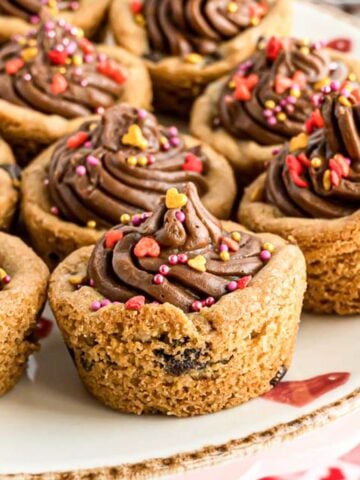 A Chocolate Chip Cookie Cup decorated with Valentine's Day sprinkles.