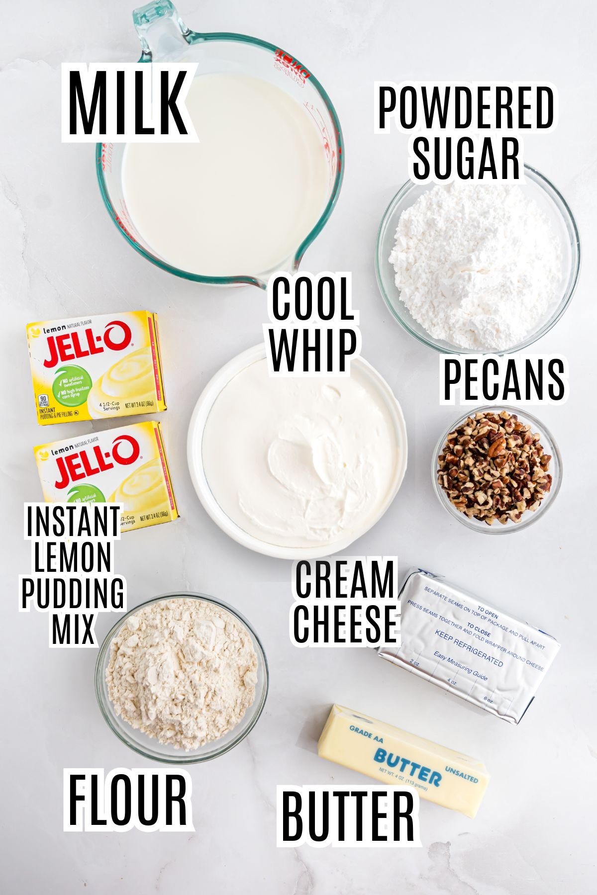 The ingredients needed to make the Lemon Lush include milk, powdered sugar, lemon instant pudding mix, Cool Whip, pecans, all-purpose flour, butter and cream cheese.