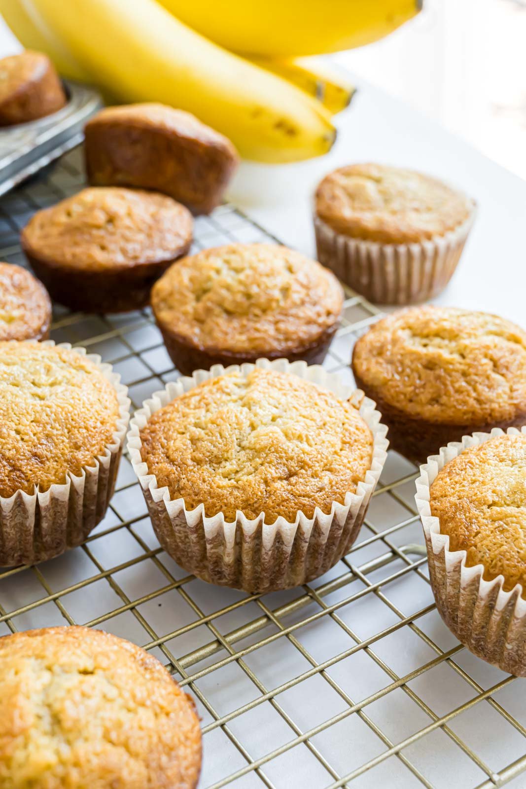 Banana muffins on a wire cooling rack.
