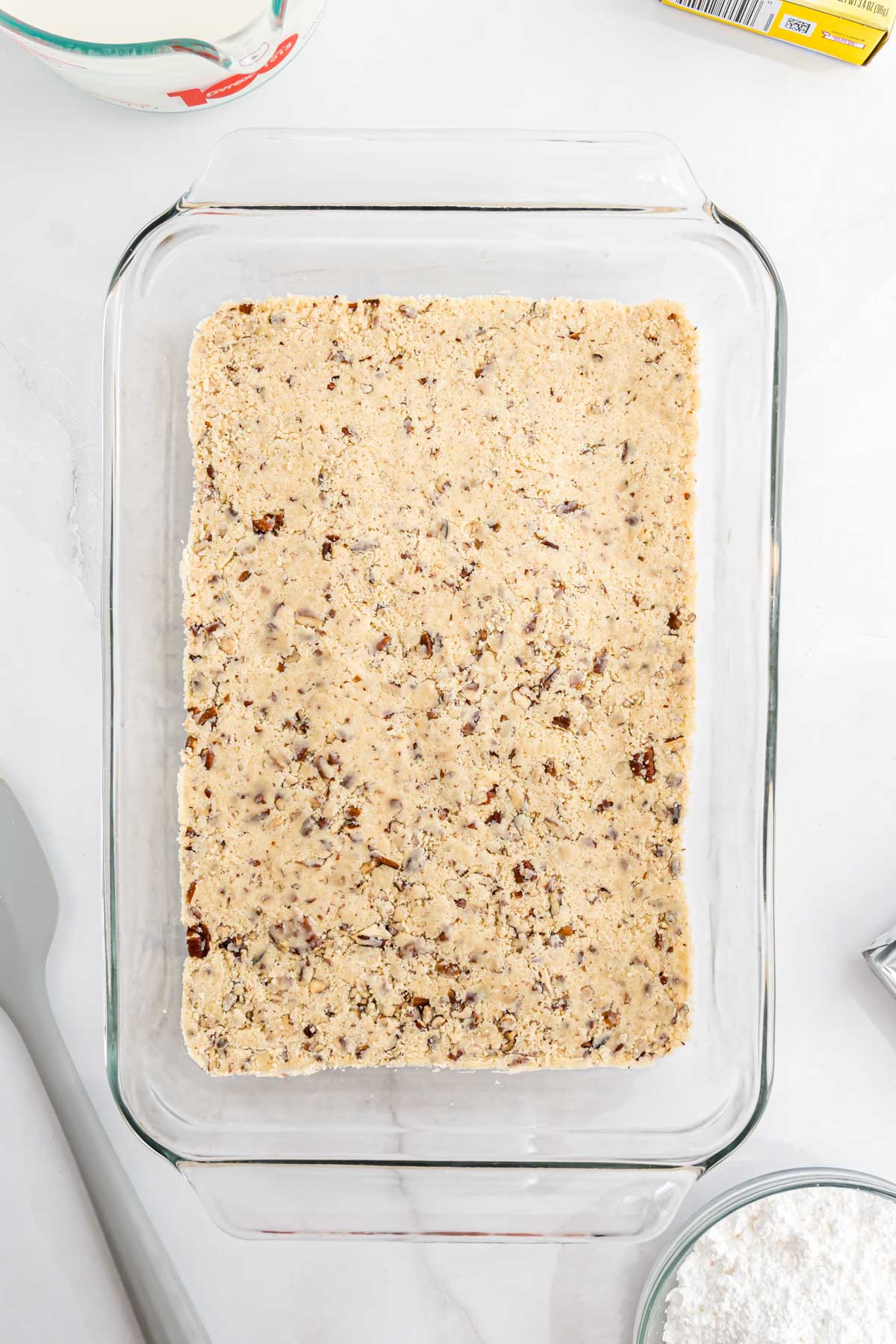 The pecan butter crust pressed into a glass 9" x 13" baking dish.