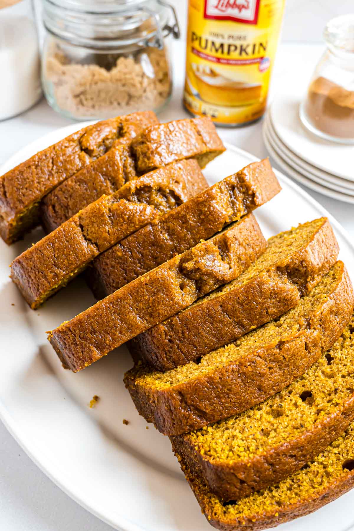 A large serving platter with a loaf of Libby's Pumpkin Bread sliced and fanned out to reveal a moist and fluffy texture.