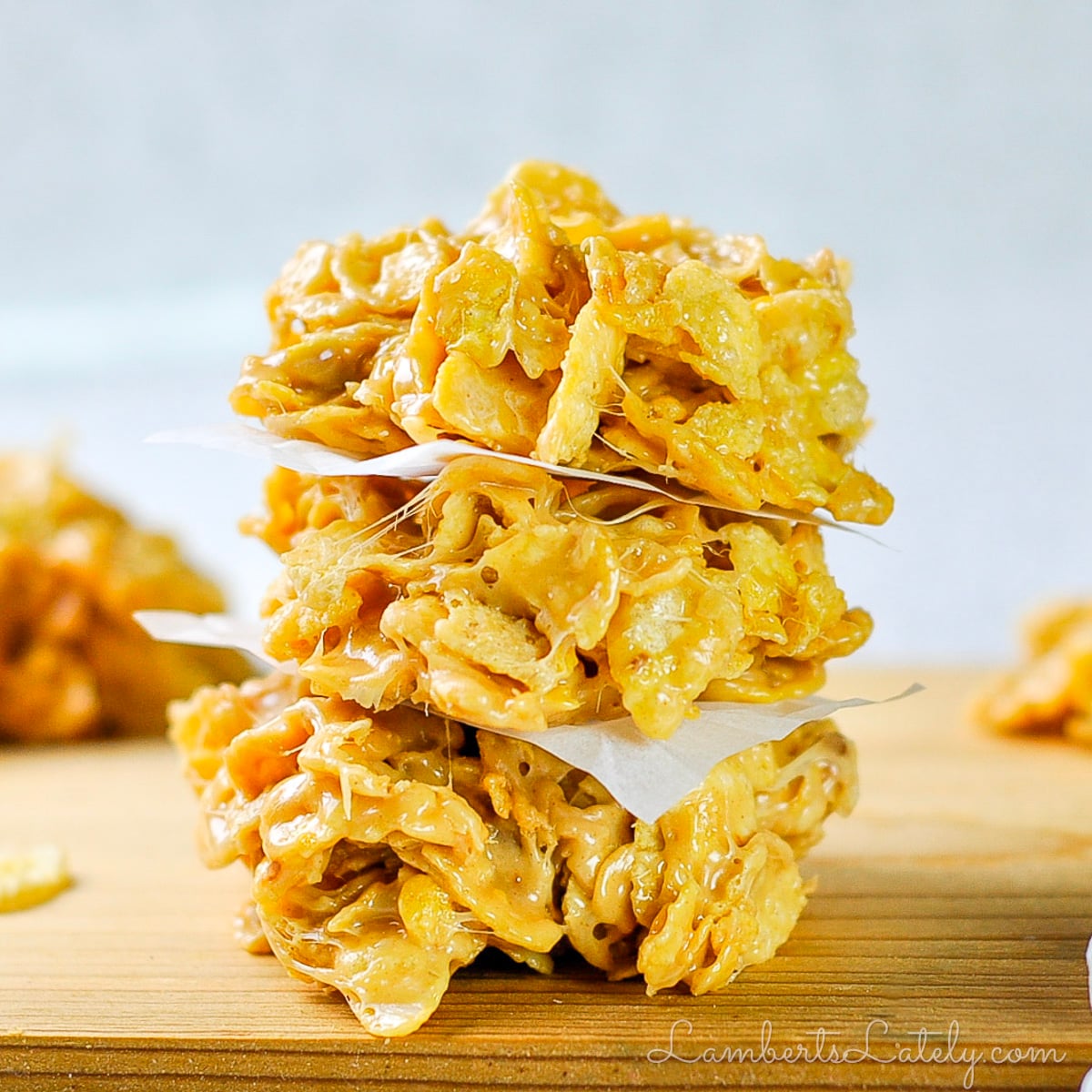 A stack of corn flake cookies with peanut butter a mini marshmallows.