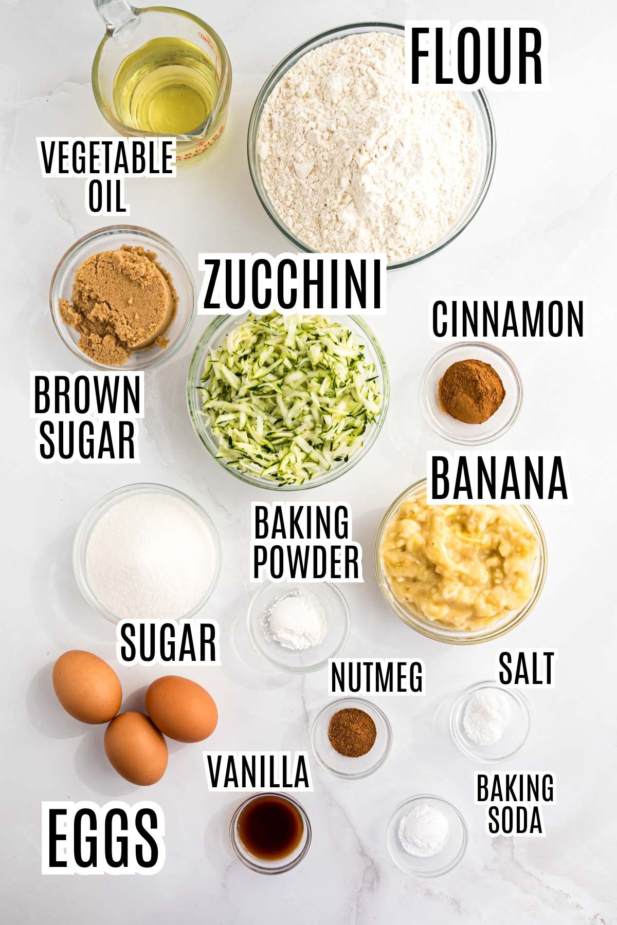 The ingredients needed to make Banana Zucchini Bread include: vegetable oil, flour, brown sugar, granulated sugar, shredded zucchini, cinnamon, baking powder, mashed banana, nutmeg, salt, eggs, vanilla, and baking soda.