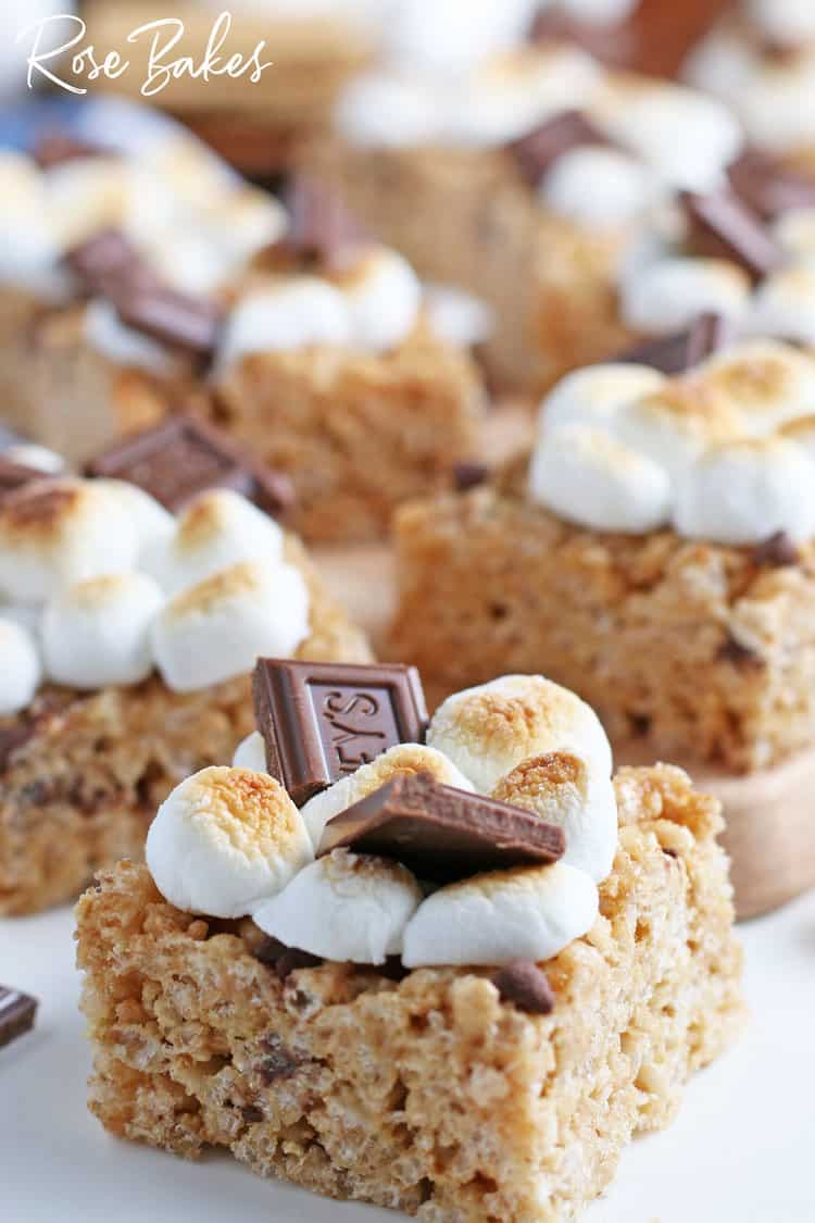 A Rice Krispie Treat topped with mini marshmallows and broken milk chocolate pieces.