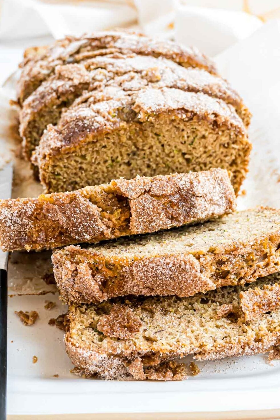 A loaf of banana zucchini bread topped with cinnamon sugar.