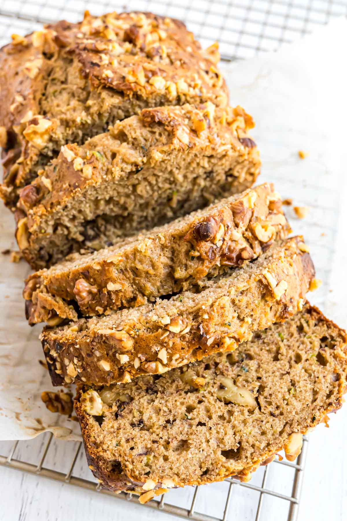 A loaf of banana zucchini bread with walnuts.