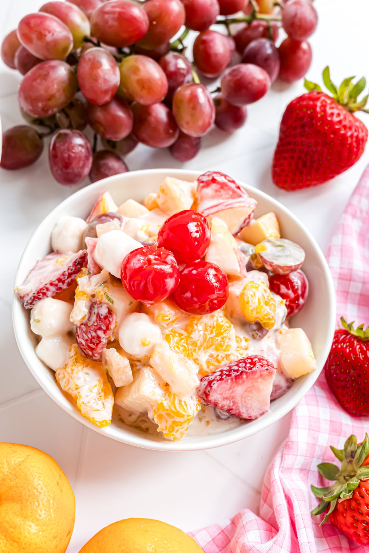 A fruit salad featuring mini marshmallows in a bowl.