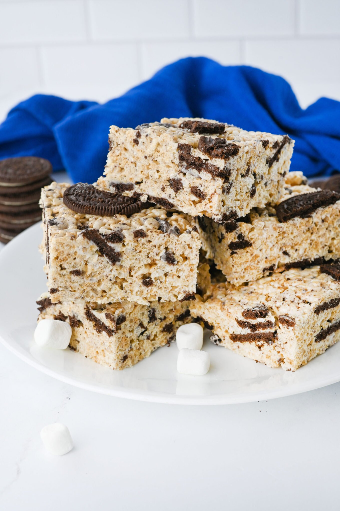 Oreo Rice Krispie treats stacked on a serving plate.