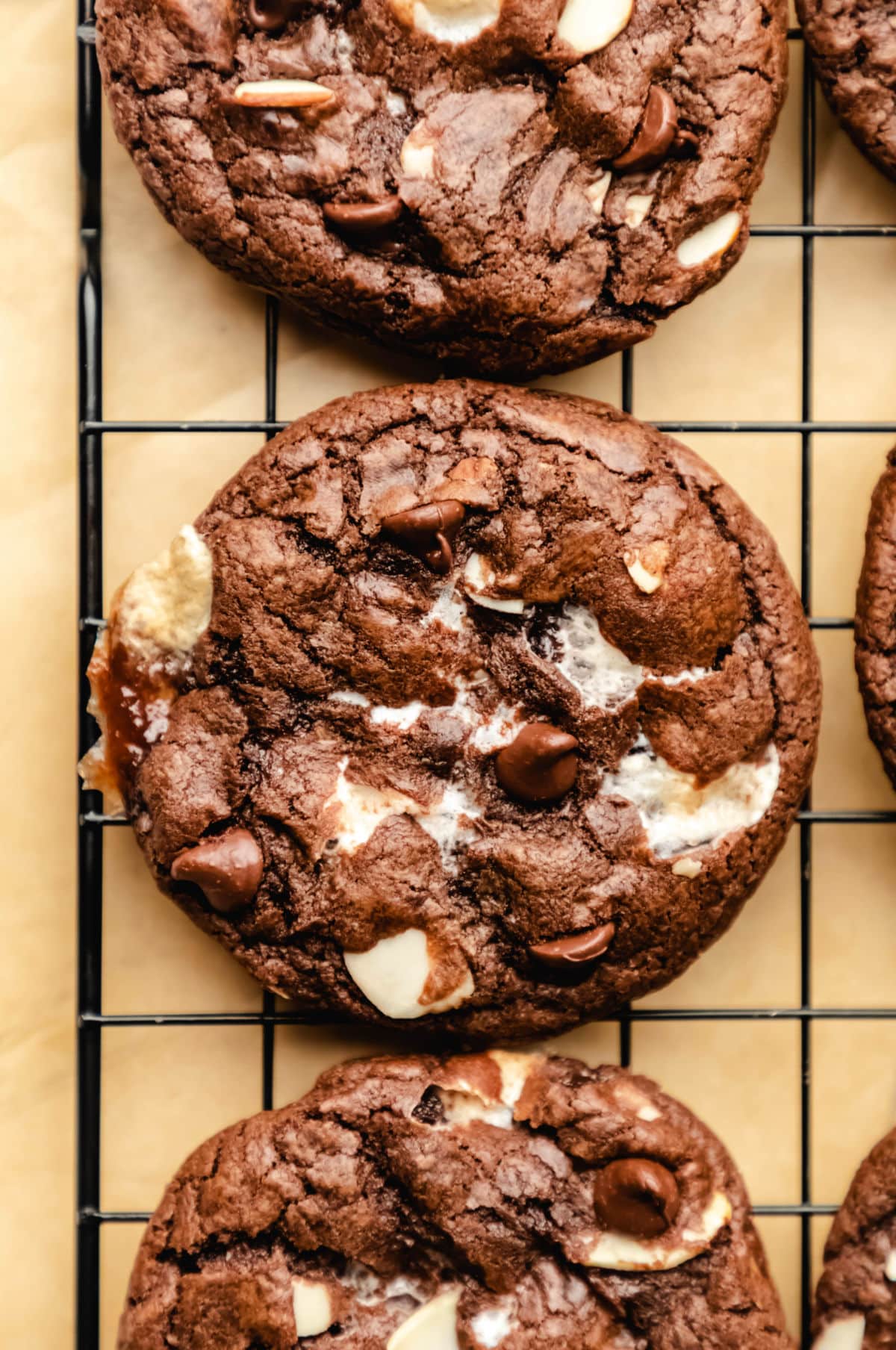 Rocky Road Cookies with marshmallows, chocolate chips, and sliced almonds, on a cooling rack.
