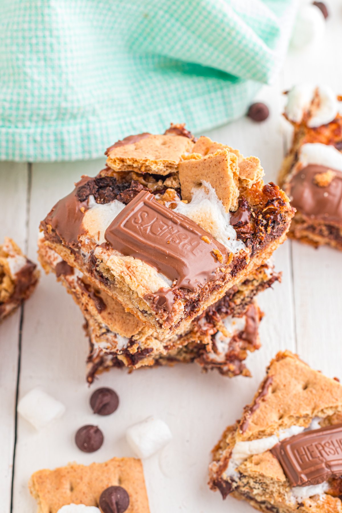 A stack of S'mores Cookie bars featuring graham crackers, hershey bar pieces and marshmallow.