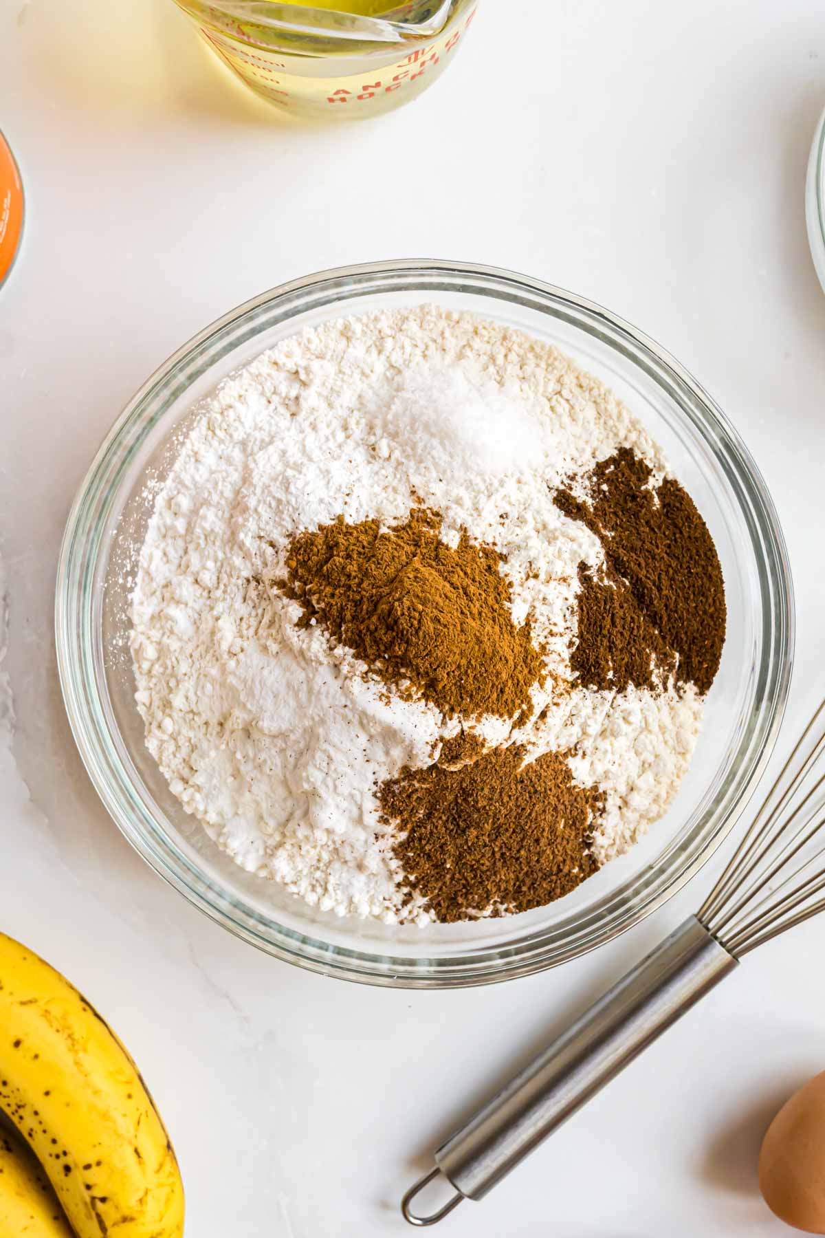 The dry ingredients for the bread whisked together in a mixing bowl.