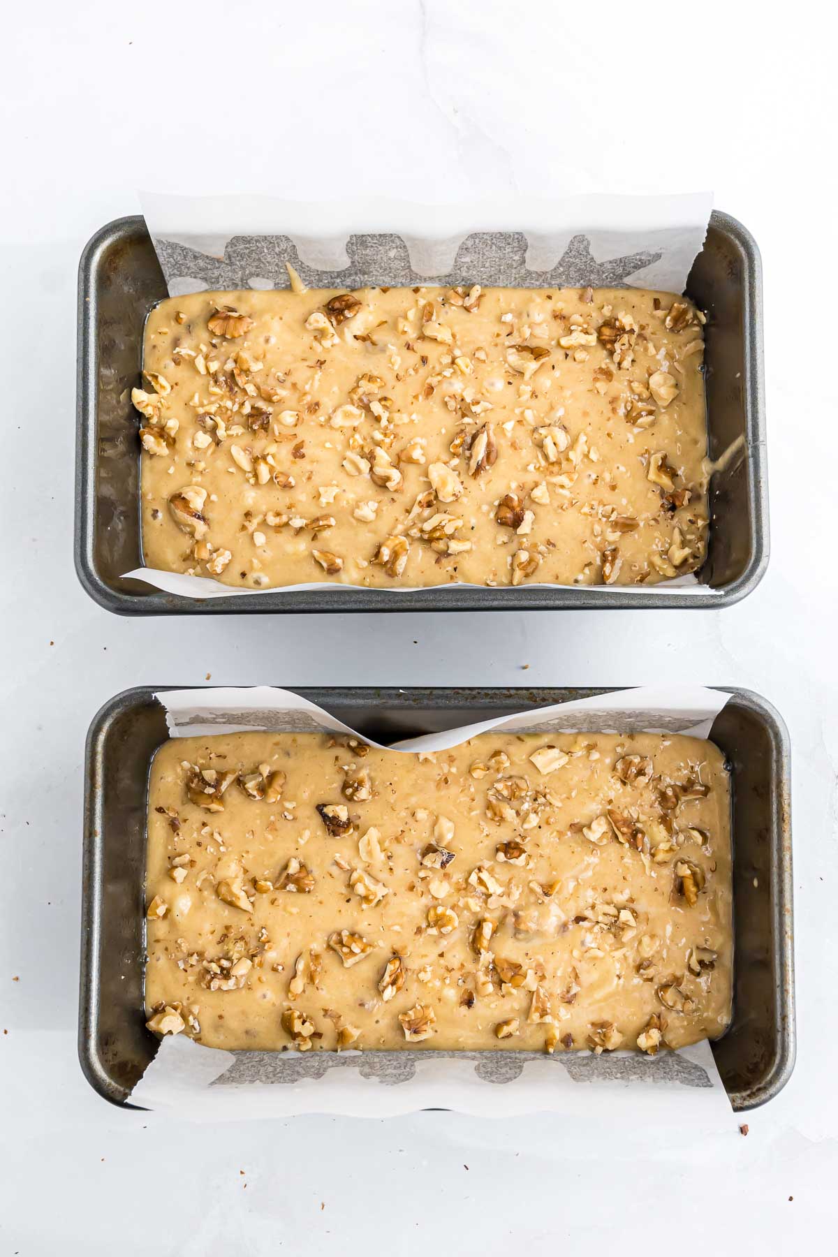 Banana Nut Bread batter in two loaf pans before baking.