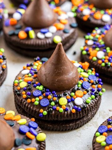 A Witch Hat Cookie made from a Hershey's kiss and an Oreo and decorated with Halloween sprinkles.