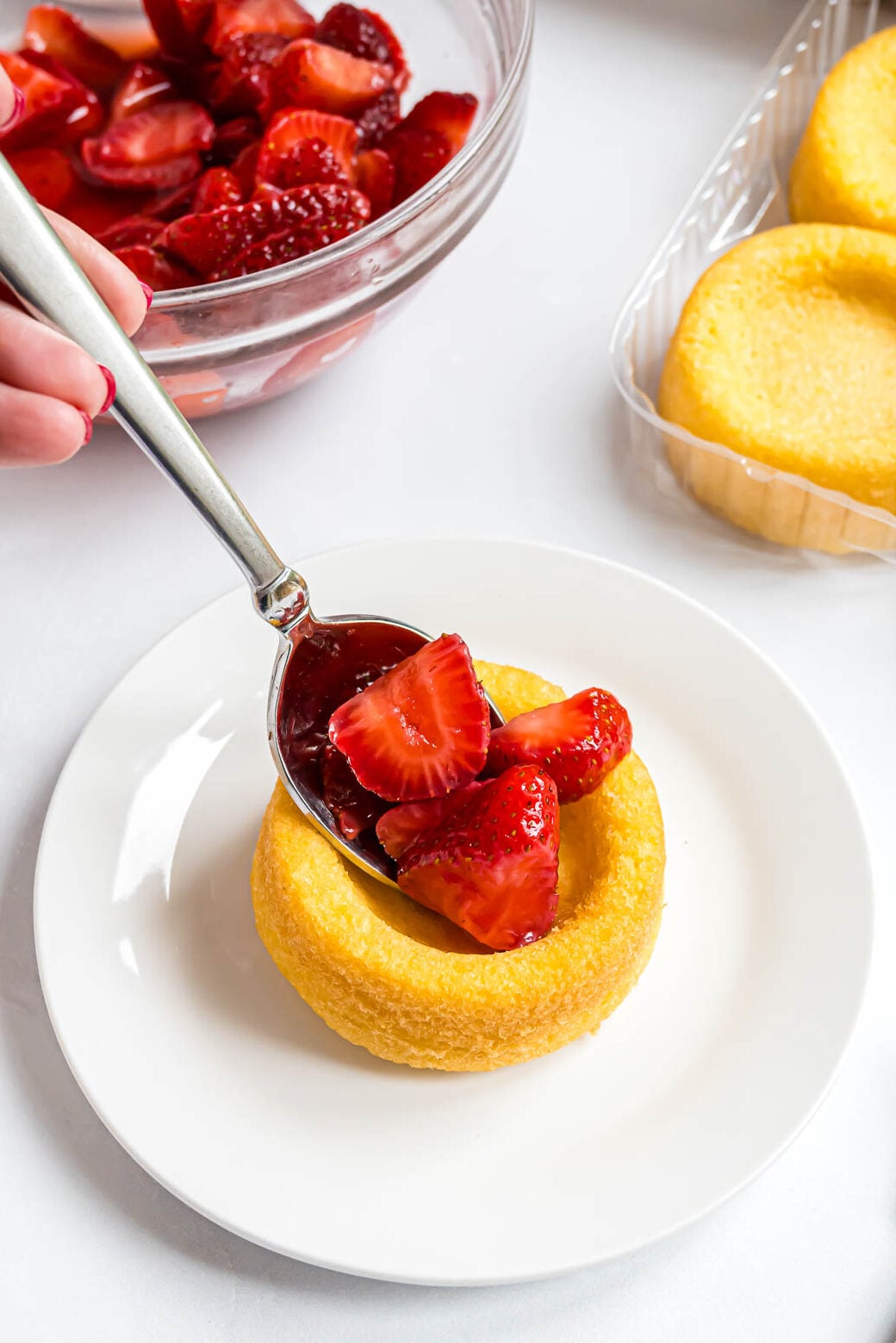 Fresh sliced strawberries spooned into a ready-made dessert shell.