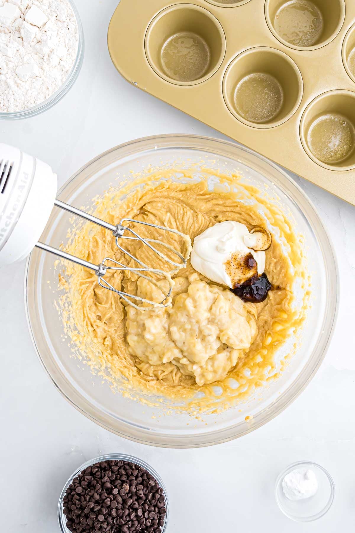 The sour cream and vanilla bean paste being added to the muffin buatter.