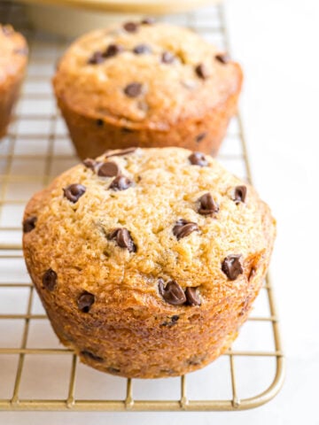 A freshly baked Banana Chocolate Chip Muffin on a cooling rack.
