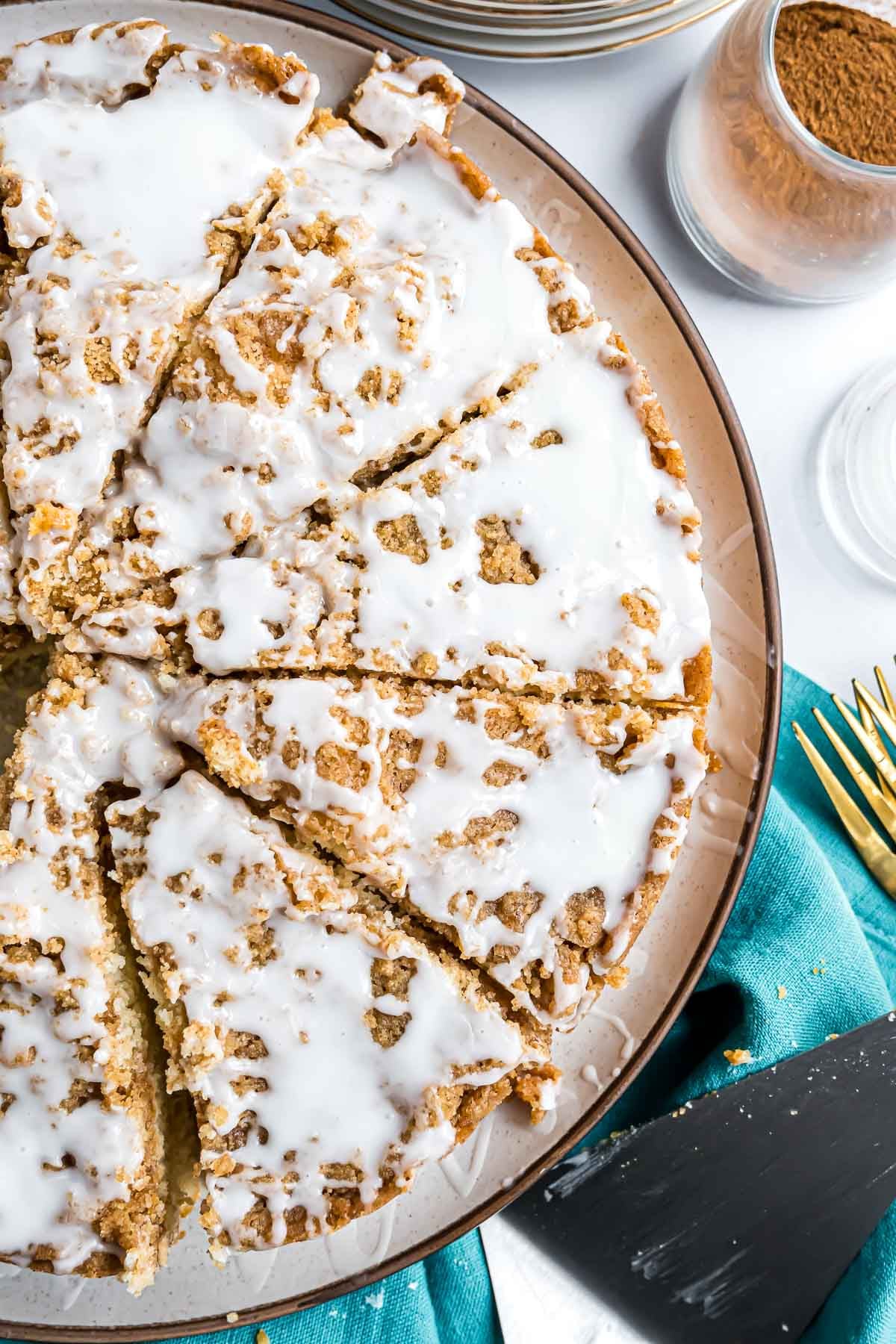 A Betty Crocker Cinnamon Streusel Coffee Cake cut into pieces on a large serving plate.