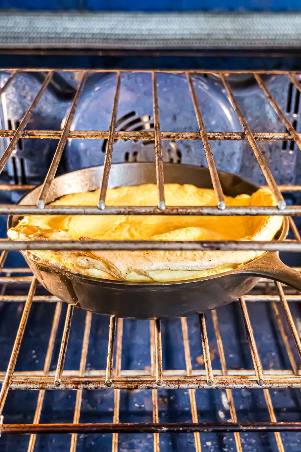 A German Pancake puffing up in the oven as it bakes in the oven.