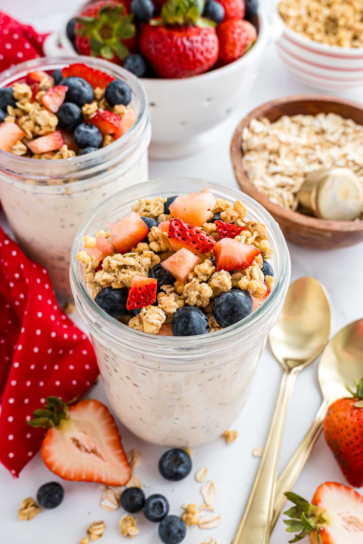 A pint jar with high protein overnight oats topped with berries and granola.