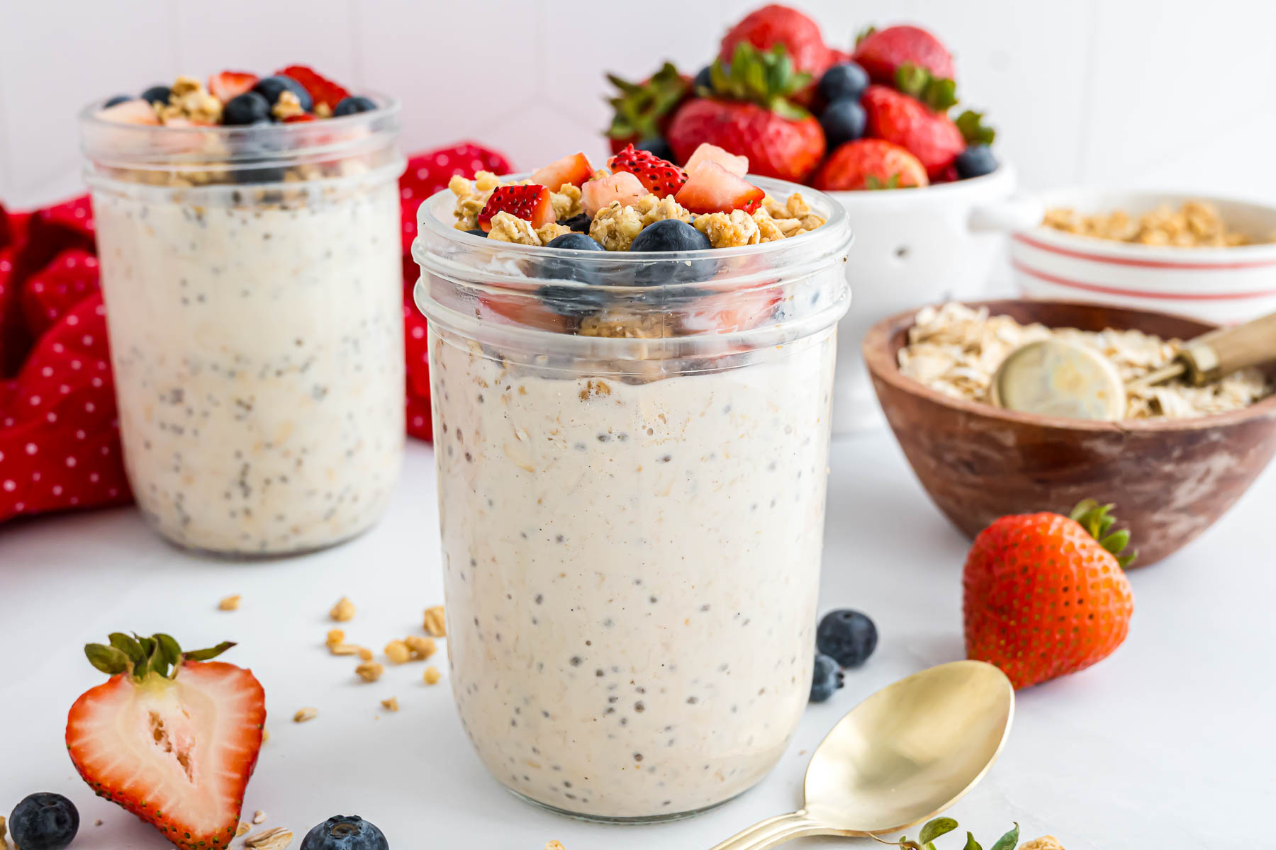 A pint jar with high protein overnight oats topped with berries and granola.
