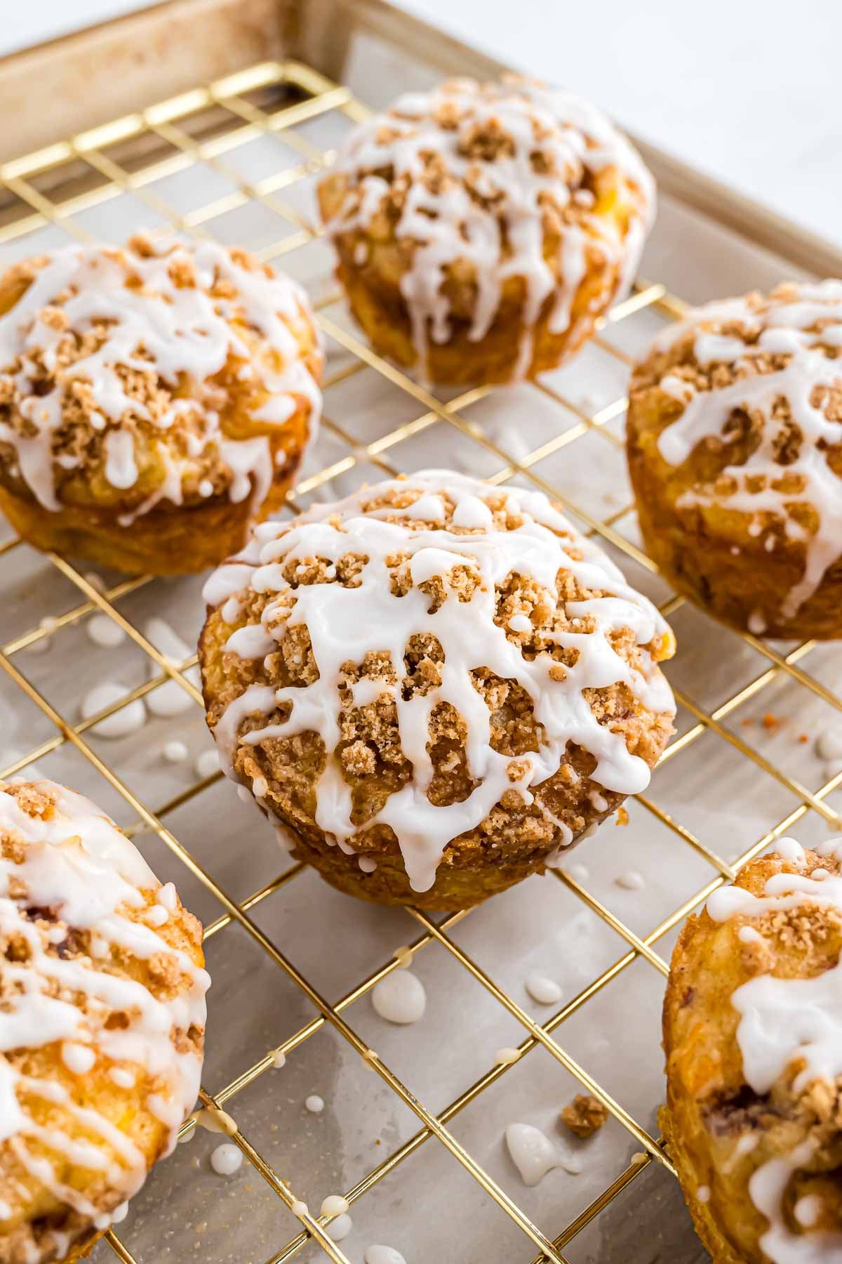 The morning glory muffins on a cooling rack after they have been glazed.
